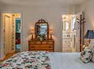 Cottage style furniture is complimented by custom window treatments, spreads and accessories