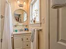 A well appointed bath with shower adjoins the bedroom